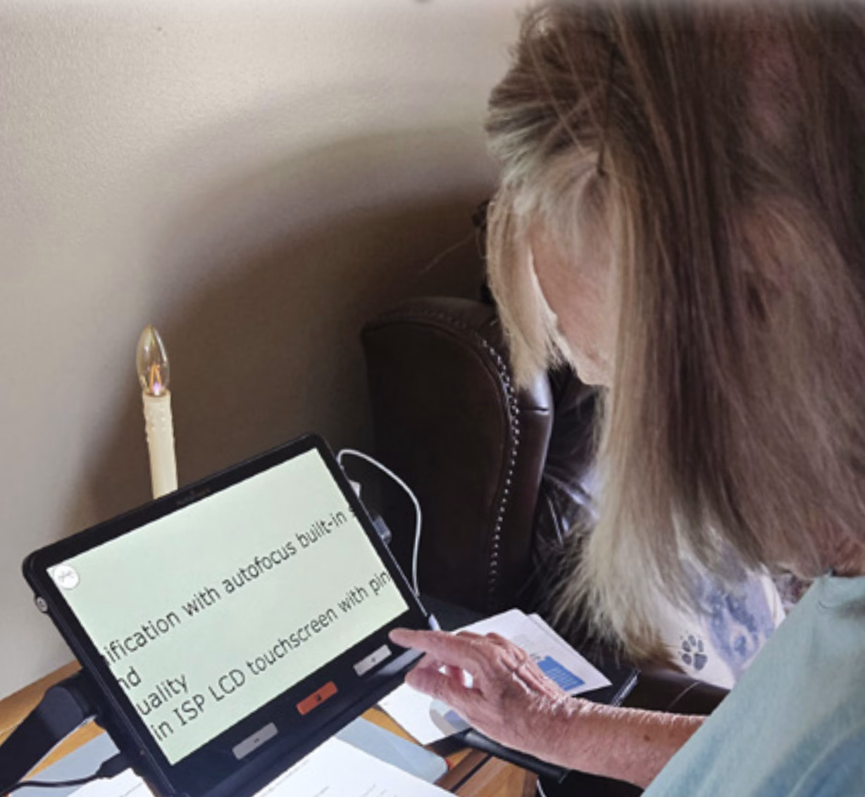 Woman using a portable magnifier